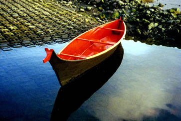 A photo of a taped-seam plywood replica Quileute dugout canoe.