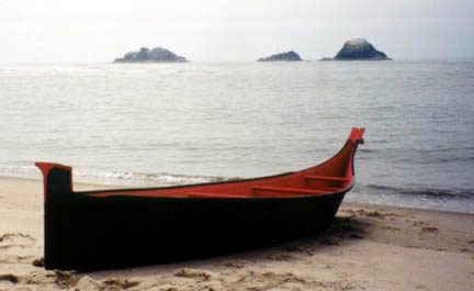 A photo of a taped-seam plywood replica of a Chinook dugout canoe.